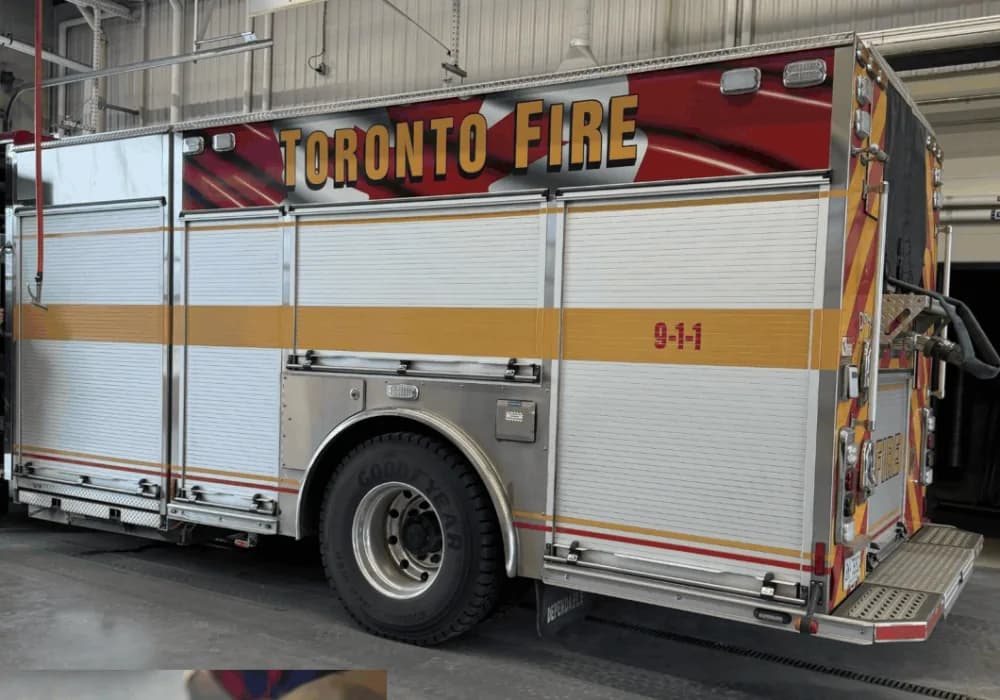 A Toronto Fire engine in the apparatus bay of a fire hall.